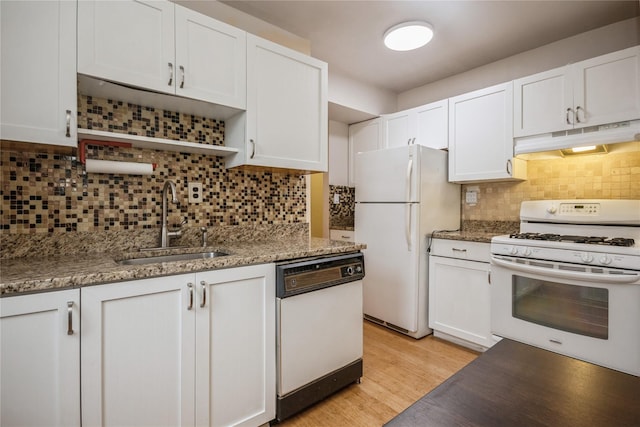 kitchen with light wood-type flooring, backsplash, white appliances, sink, and white cabinets