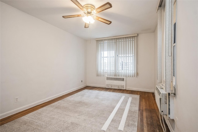 unfurnished room with radiator, ceiling fan, and dark hardwood / wood-style flooring