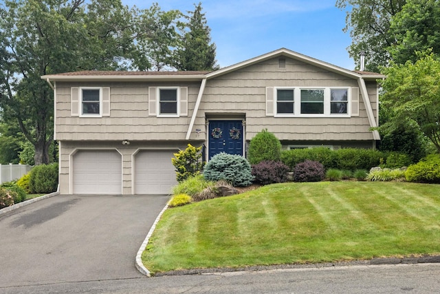 27 Stubbe Dr, Stony Point, NY 10980 - raised ranch with asphalt driveway, a front lawn, and an attached garage