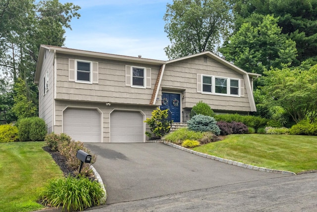 27 Stubbe Dr, Stony Point, NY 10980 - raised ranch featuring asphalt driveway, an attached garage, and a front lawn
