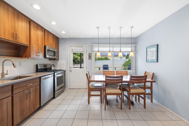 27 Stubbe Dr, Stony Point, NY 10980 - kitchen with appliances with stainless steel finishes, brown cabinets, recessed lighting, pendant lighting, and decorative backsplash