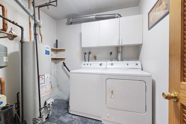 27 Stubbe Dr, Stony Point, NY 10980 - washroom with gas water heater, washing machine and clothes dryer, cabinet space, and dark tile patterned floors