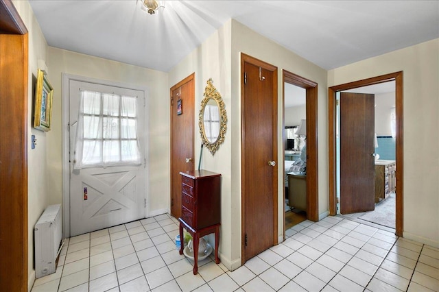 entryway featuring radiator and light tile patterned flooring