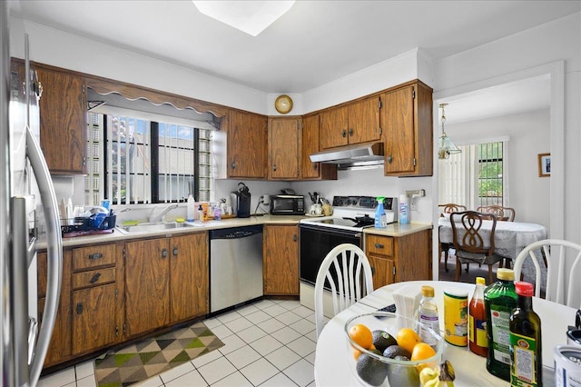 kitchen featuring sink, light tile patterned floors, and stainless steel appliances