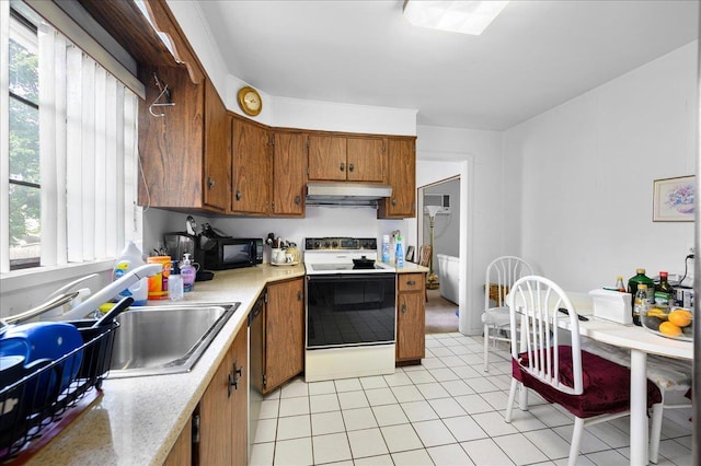 kitchen featuring white range with electric cooktop, plenty of natural light, light tile patterned floors, and sink