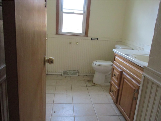 bathroom featuring tile patterned flooring, vanity, and toilet