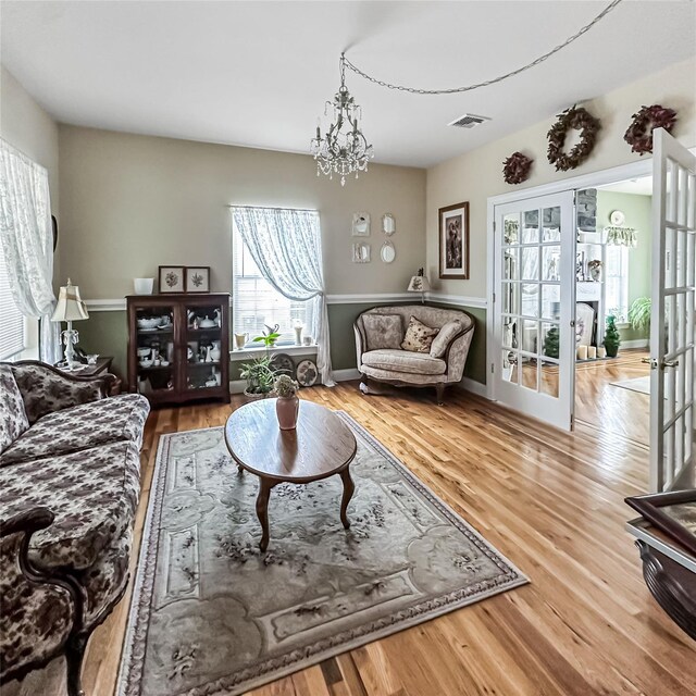 37 Woodcock Mtn Rd, Washingtonville, NY 10992 - living room with french doors, wood finished floors, and a chandelier