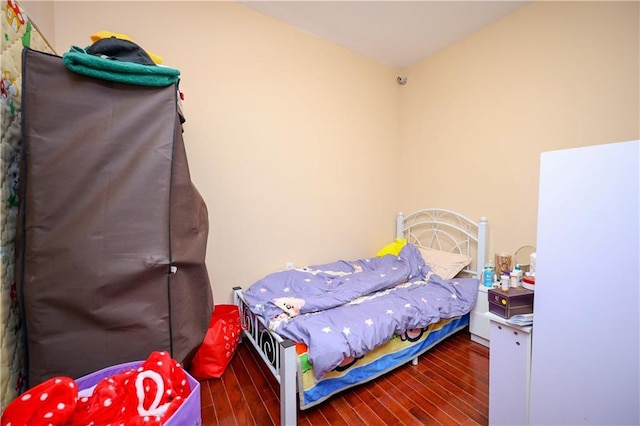 bedroom with dark wood-type flooring