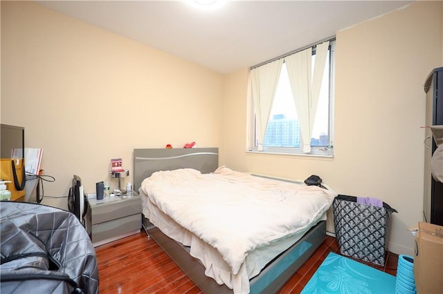 bedroom with dark wood-type flooring