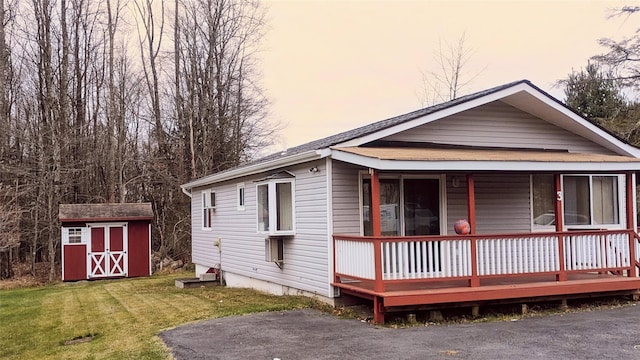 exterior space with a lawn and a storage shed