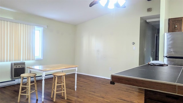 rec room with ceiling fan, a wall mounted air conditioner, and dark hardwood / wood-style floors