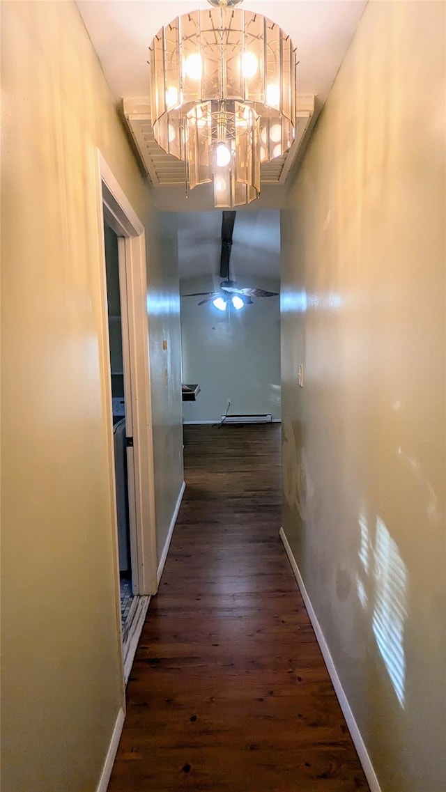 hallway featuring a chandelier and dark hardwood / wood-style flooring