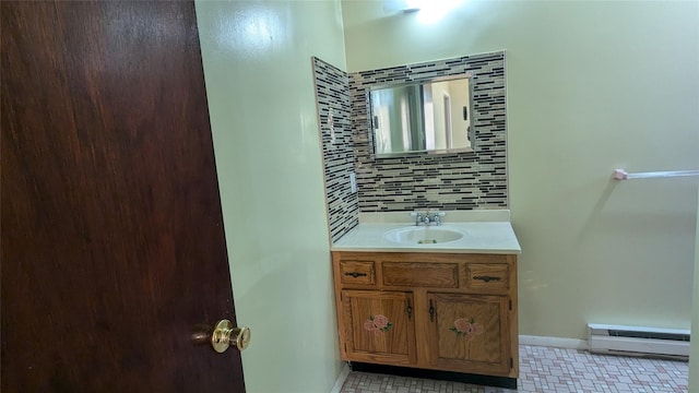 bathroom with decorative backsplash, vanity, and a baseboard radiator