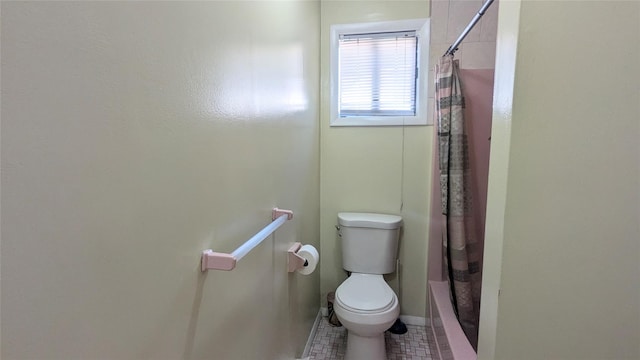 bathroom with shower / bath combination with curtain and toilet