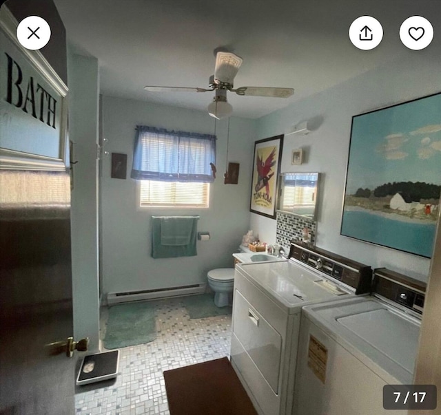 bathroom featuring washing machine and clothes dryer, ceiling fan, baseboard heating, toilet, and vanity