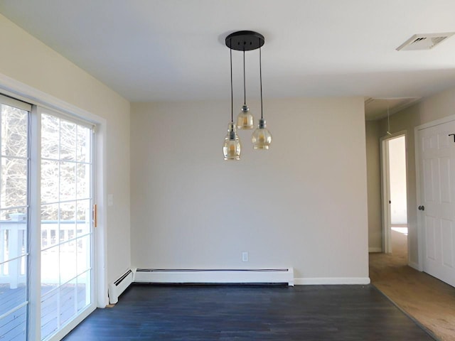 spare room featuring dark hardwood / wood-style floors and baseboard heating