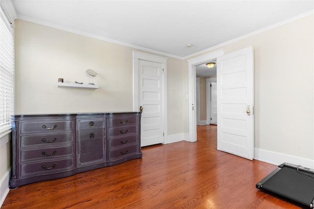 bedroom with wood-type flooring and ornamental molding