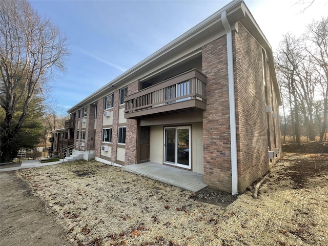 3 Woods End Cir Unit 3P, Peekskill, NY 10566 - back of house with a balcony and brick siding