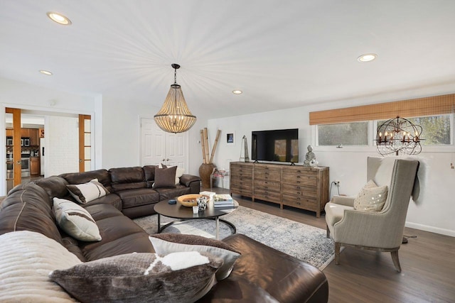 living room featuring a chandelier and dark hardwood / wood-style flooring