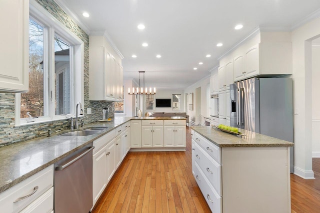 kitchen with dishwasher, hanging light fixtures, light wood-type flooring, white cabinets, and sink