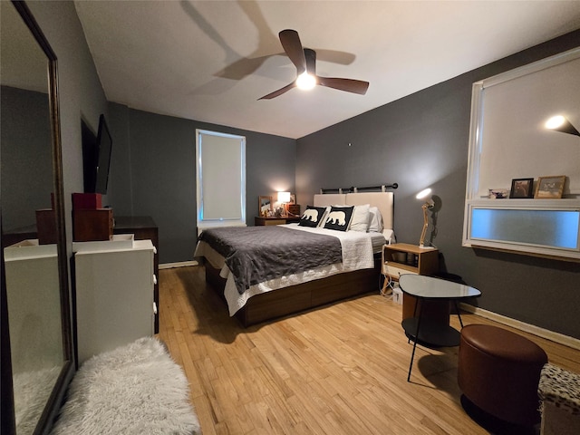 bedroom with light hardwood / wood-style flooring and ceiling fan