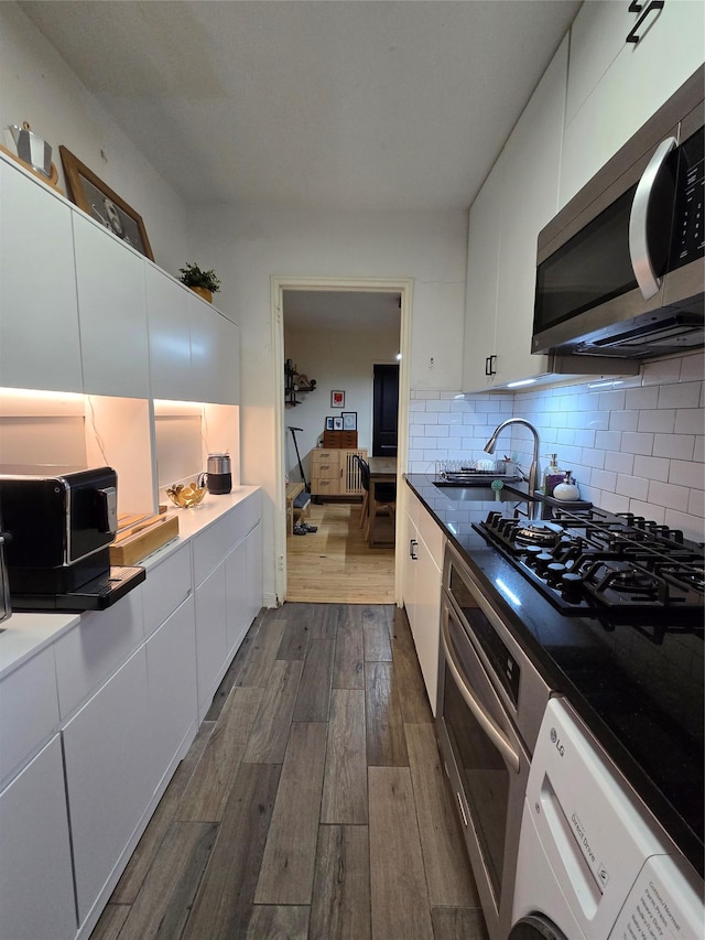 kitchen featuring tasteful backsplash, white cabinetry, and tile counters