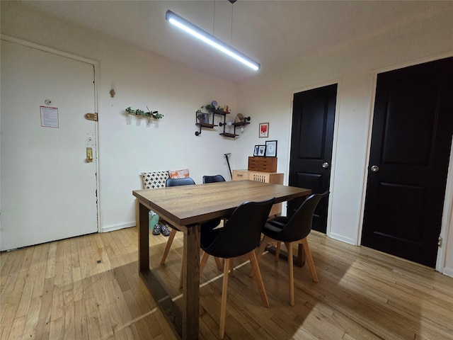 dining space with light wood-type flooring