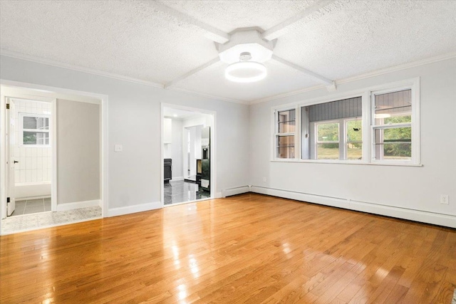 spare room featuring hardwood / wood-style floors, a textured ceiling, and a baseboard radiator