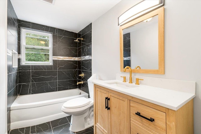 full bathroom featuring vanity, toilet, and tiled shower / bath