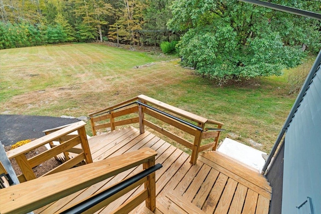 wooden deck featuring a lawn