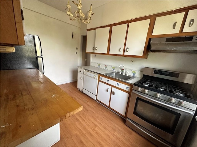 kitchen with stainless steel gas range oven, an inviting chandelier, white dishwasher, white cabinets, and sink