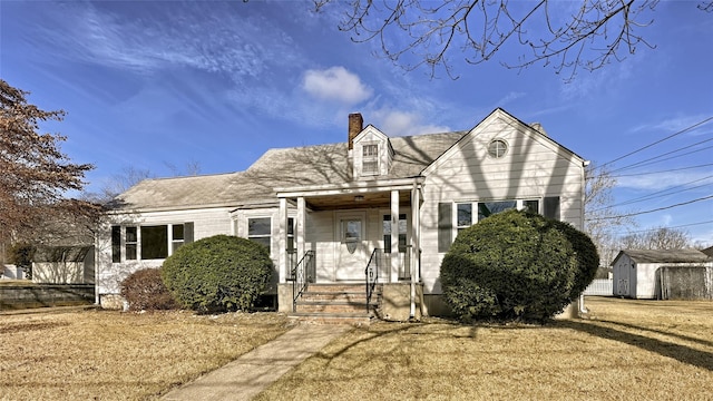 view of front of property with a storage shed