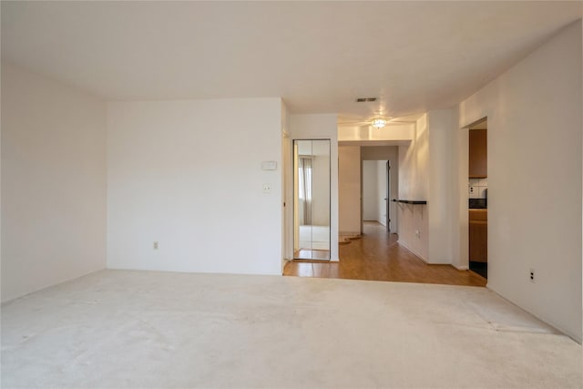 spare room featuring ceiling fan and light wood-type flooring