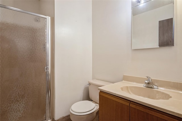 bathroom featuring vanity, toilet, and an enclosed shower