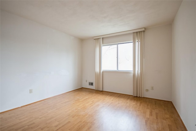 spare room featuring light hardwood / wood-style floors