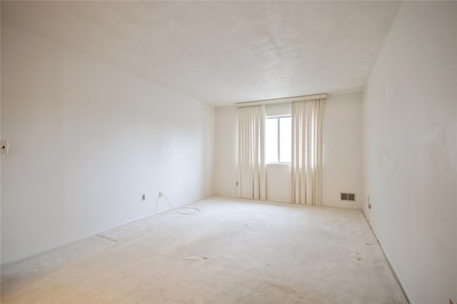 empty room featuring light colored carpet