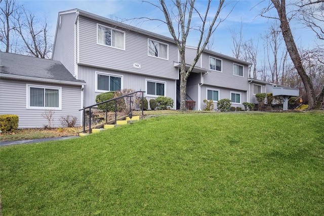 rear view of property featuring a yard