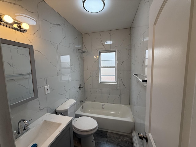 full bathroom with tiled shower / bath combo, baseboard heating, tile walls, and vanity