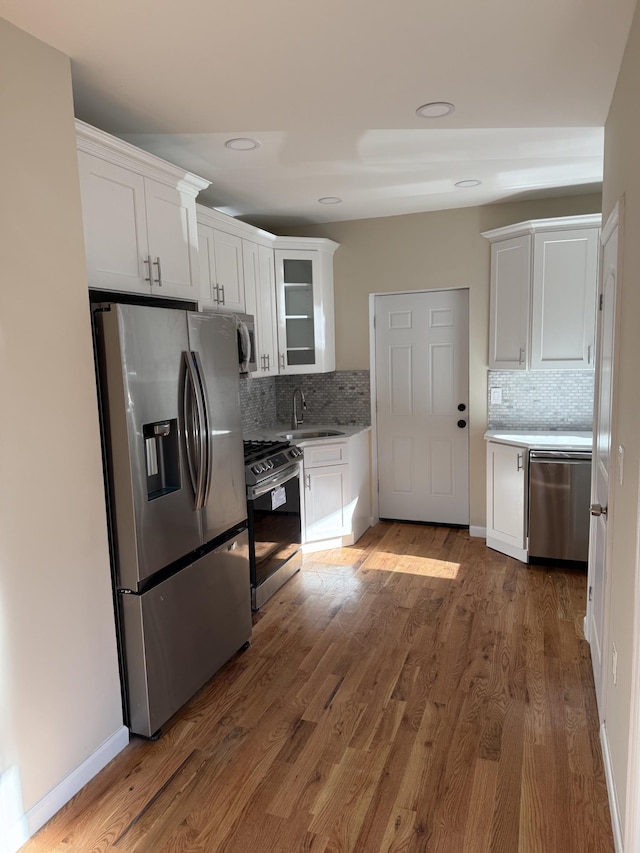 kitchen with white cabinets and wood walls