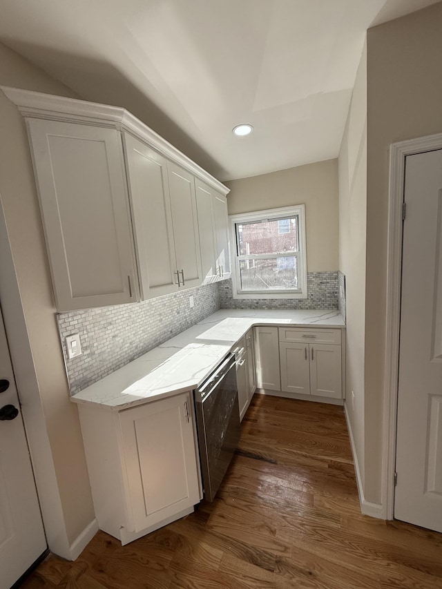 kitchen featuring white cabinets and wood walls