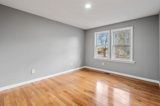 empty room with light hardwood / wood-style floors