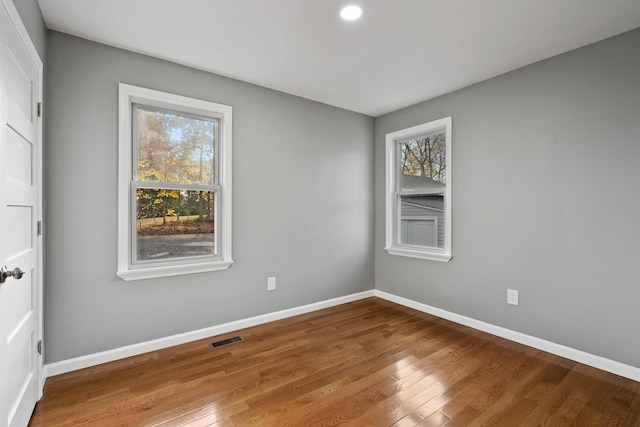 spare room featuring hardwood / wood-style floors