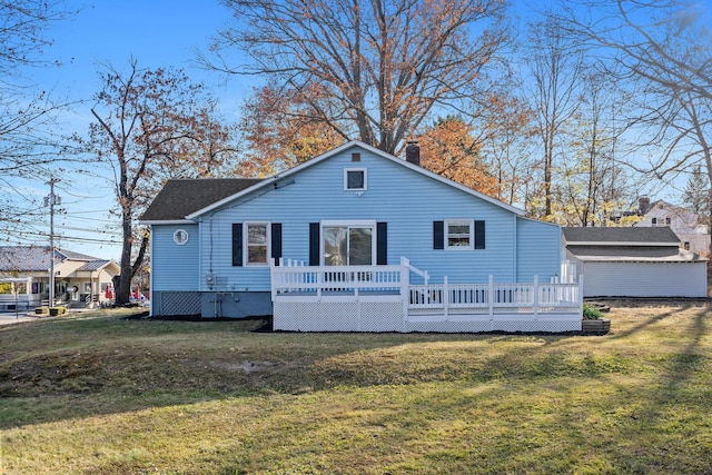 rear view of house featuring a lawn and a wooden deck