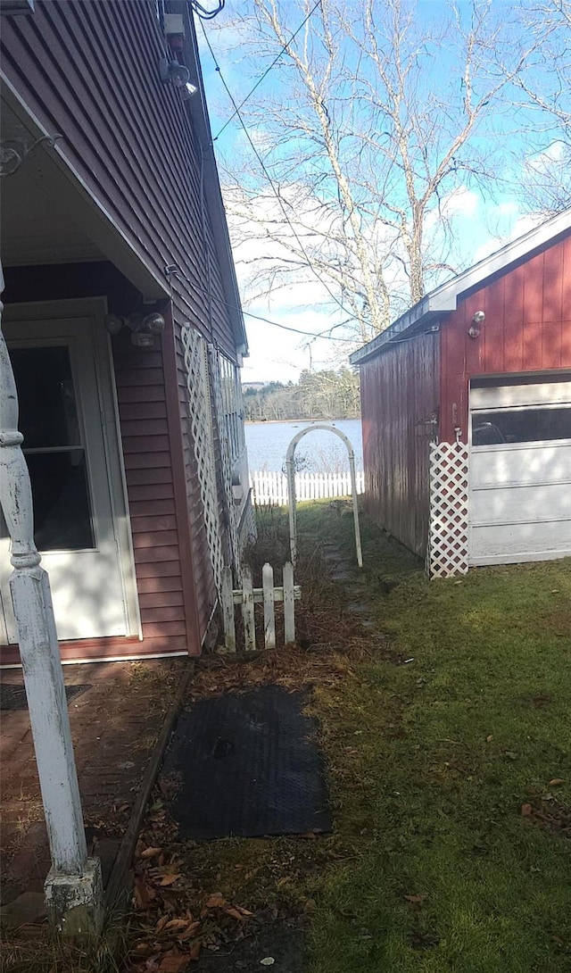 view of side of property with an outbuilding and a water view