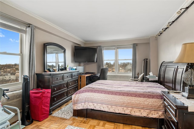 bedroom with multiple windows, light parquet floors, and ornamental molding