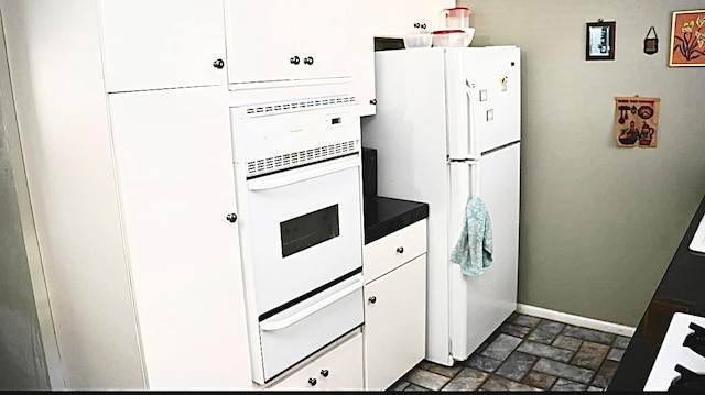 kitchen with white cabinetry and white appliances