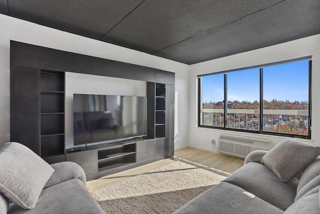 500 High Point Dr Unit 709, Hartsdale, NY 10530 - living room featuring wood finished floors and a wall unit AC