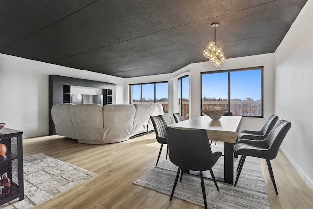 500 High Point Dr Unit 709, Hartsdale, NY 10530 - dining area featuring light wood finished floors and a chandelier