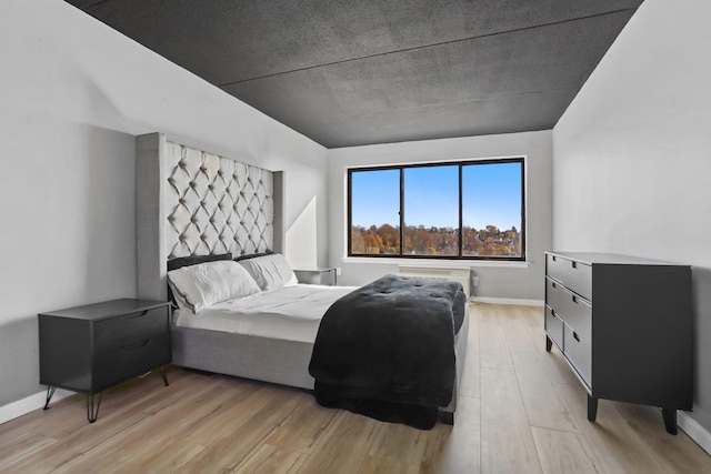 500 High Point Dr Unit 709, Hartsdale, NY 10530 - bedroom with light wood-style flooring and a wall unit AC