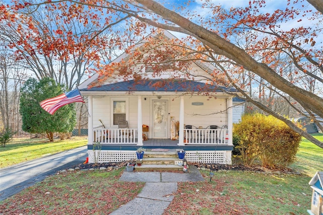 view of front of house with a front yard and covered porch